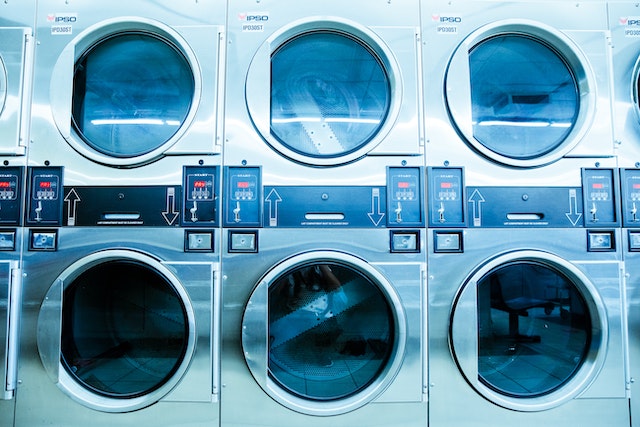 A series of washers at a laundromat