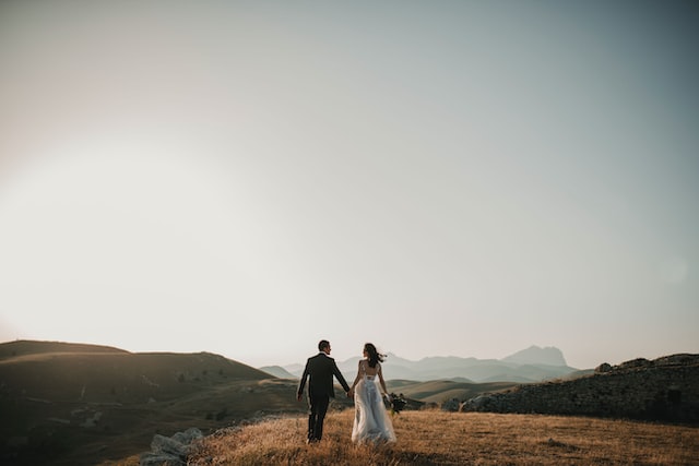 Couple on wedding day in the distance of an open field